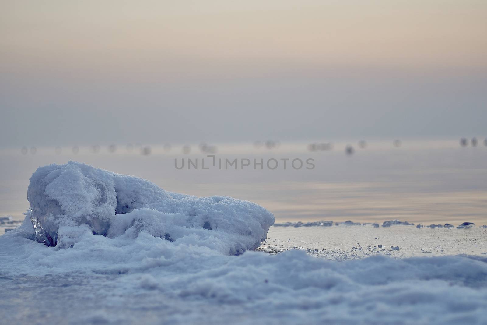 Thin, transparent ice and snow on a frozen lake in Bavaria