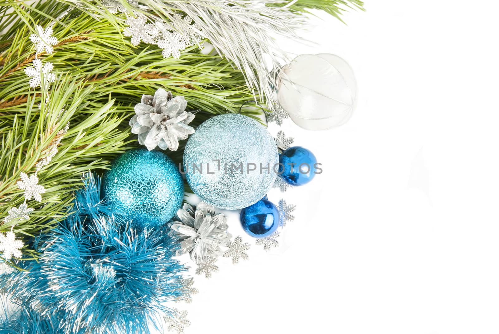 New Year composition with fir tree branch and cones with blue balls and tinsel isolated on white background