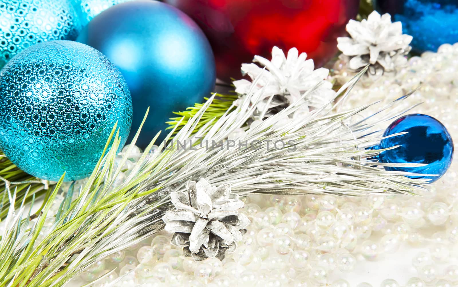 New year decorations on white beads background with balls and fir tree branch