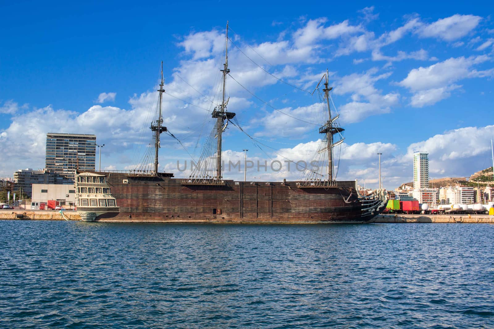 View on big old wooden vessel in marina on Mediterranean sea coast in Spain Alicante