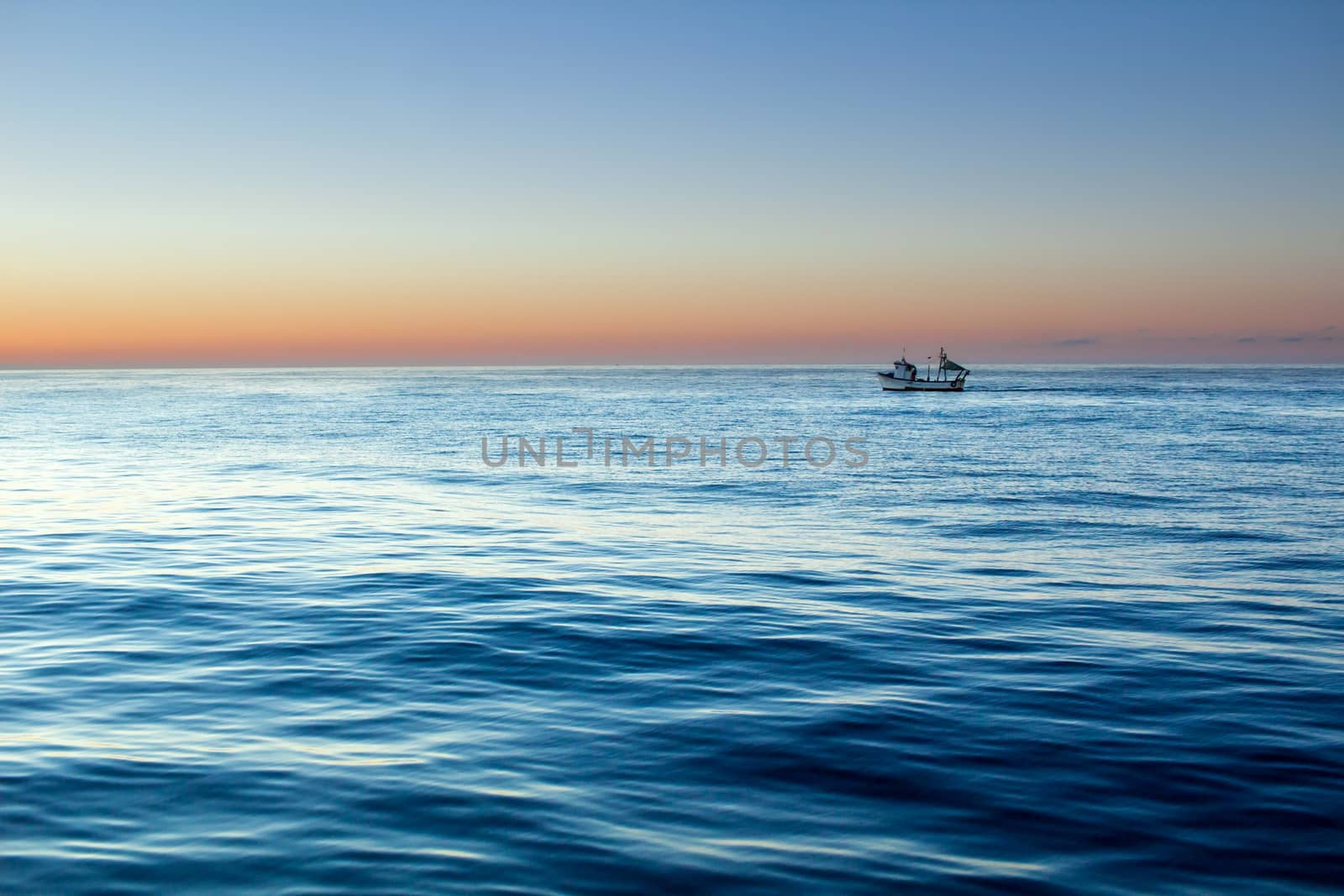 Sunset sunrise in open sea with dramatic cloudy calm clear sky