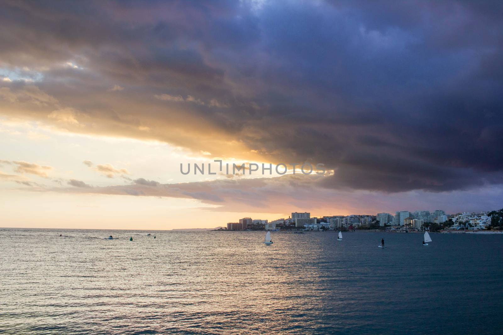 Sunset sunrise in open sea with dramatic cloudy calm clear sky
