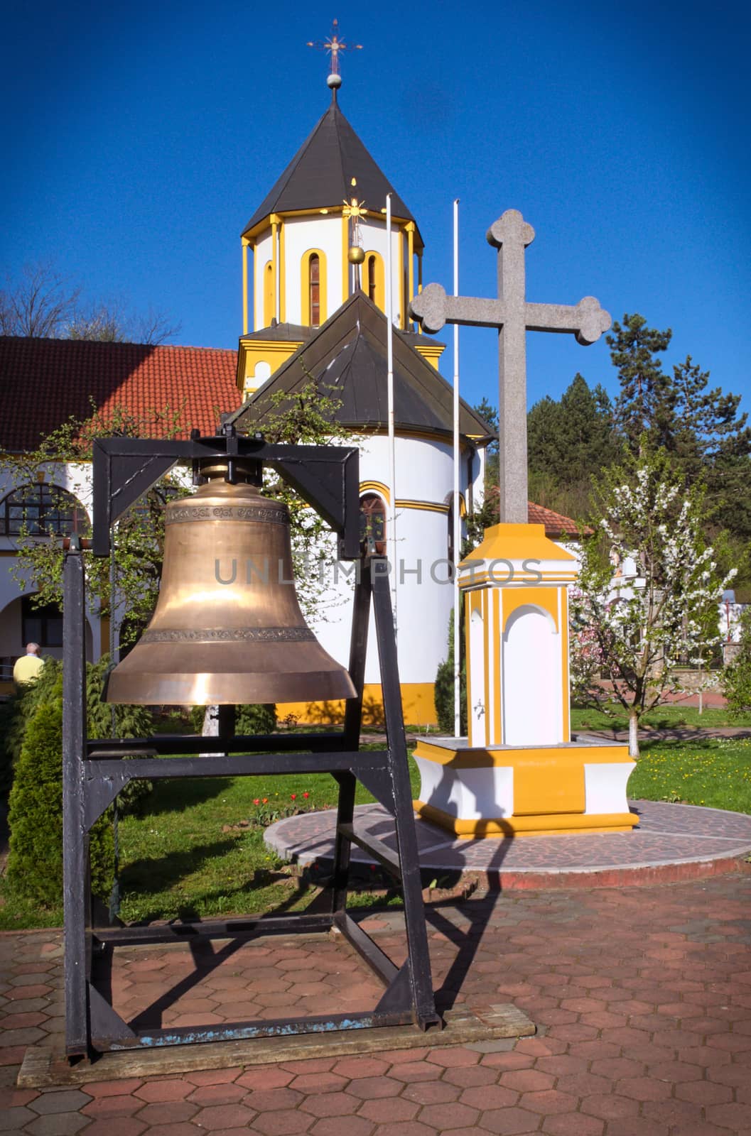 Bell and cross in front of church, Privina Glava, Serbia