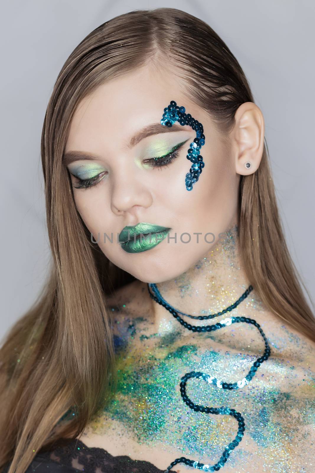 Fashion Art Portrait .Green Make-up and Colorful Bright Nails.