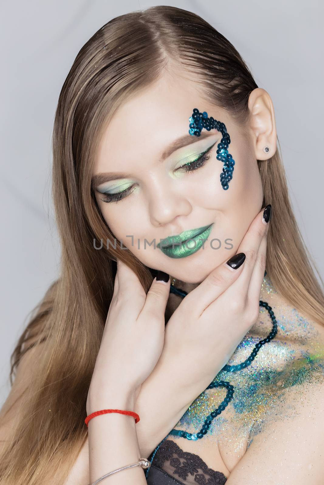 Fashion Art Portrait .Green Make-up and Colorful Bright Nails.