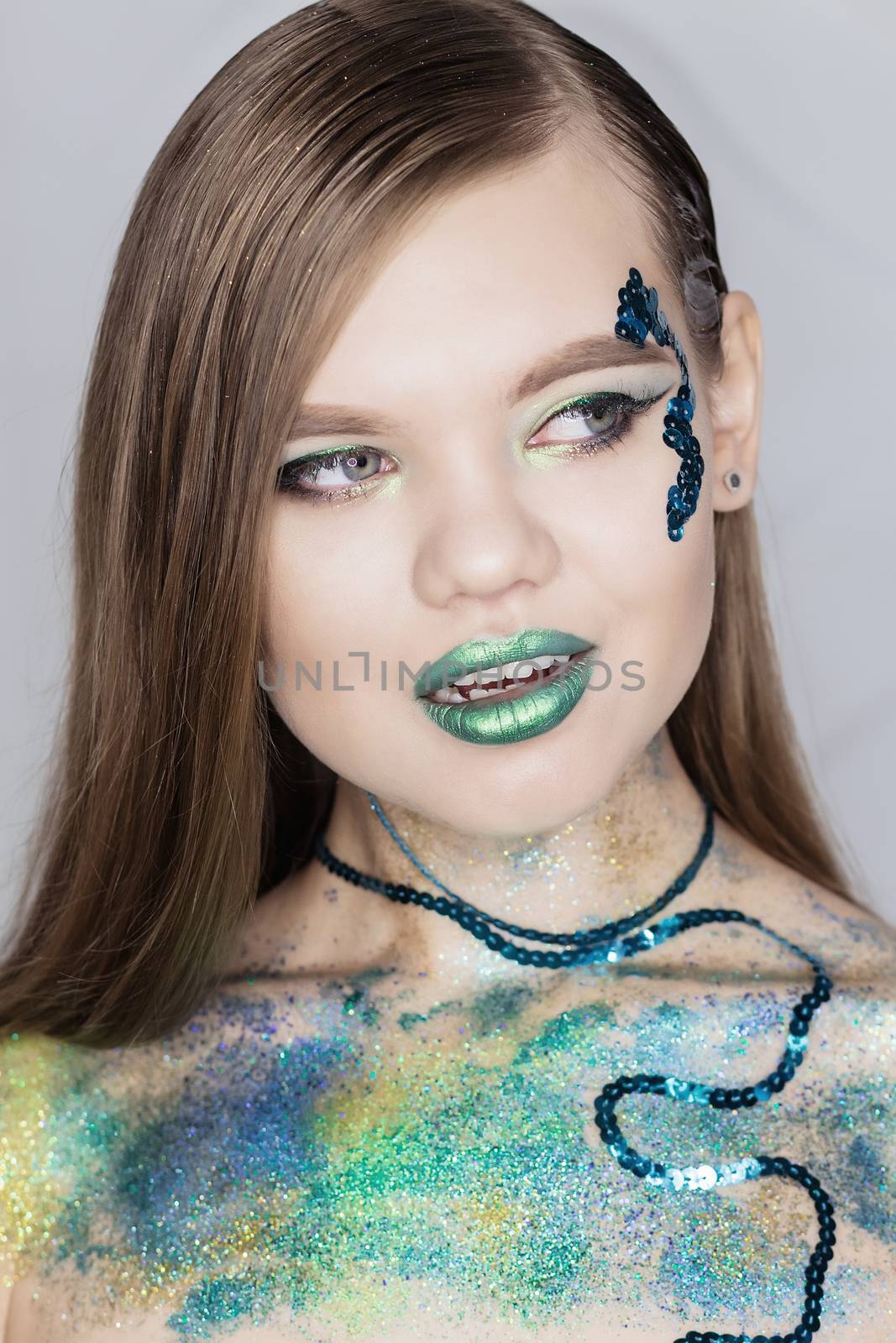 Fashion Art Portrait .Green Make-up and Colorful Bright Nails.