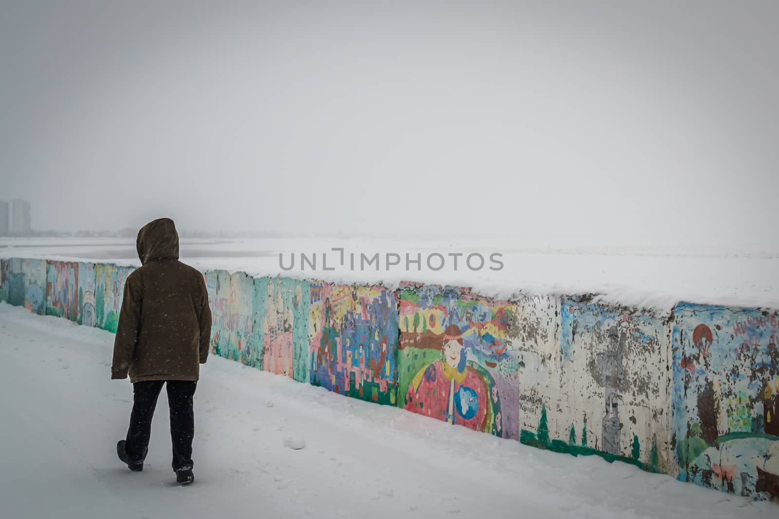 the lone man looks at water winter old man