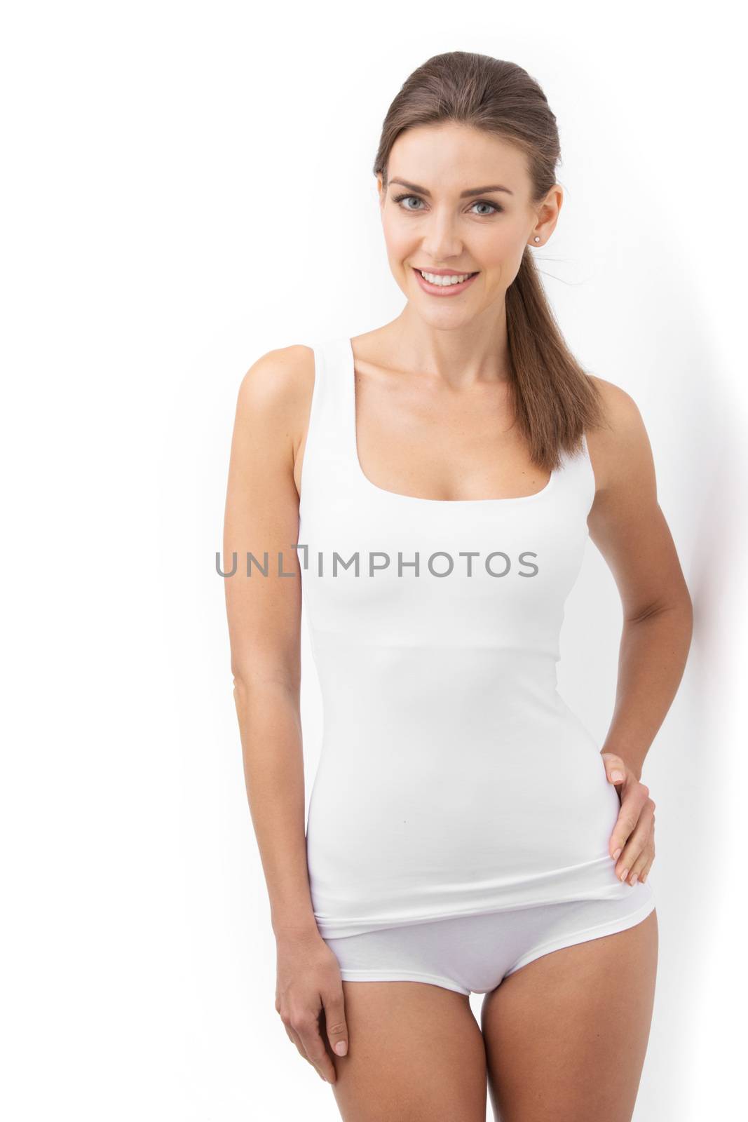 Young beautiful woman in cotton underwear posing on white background