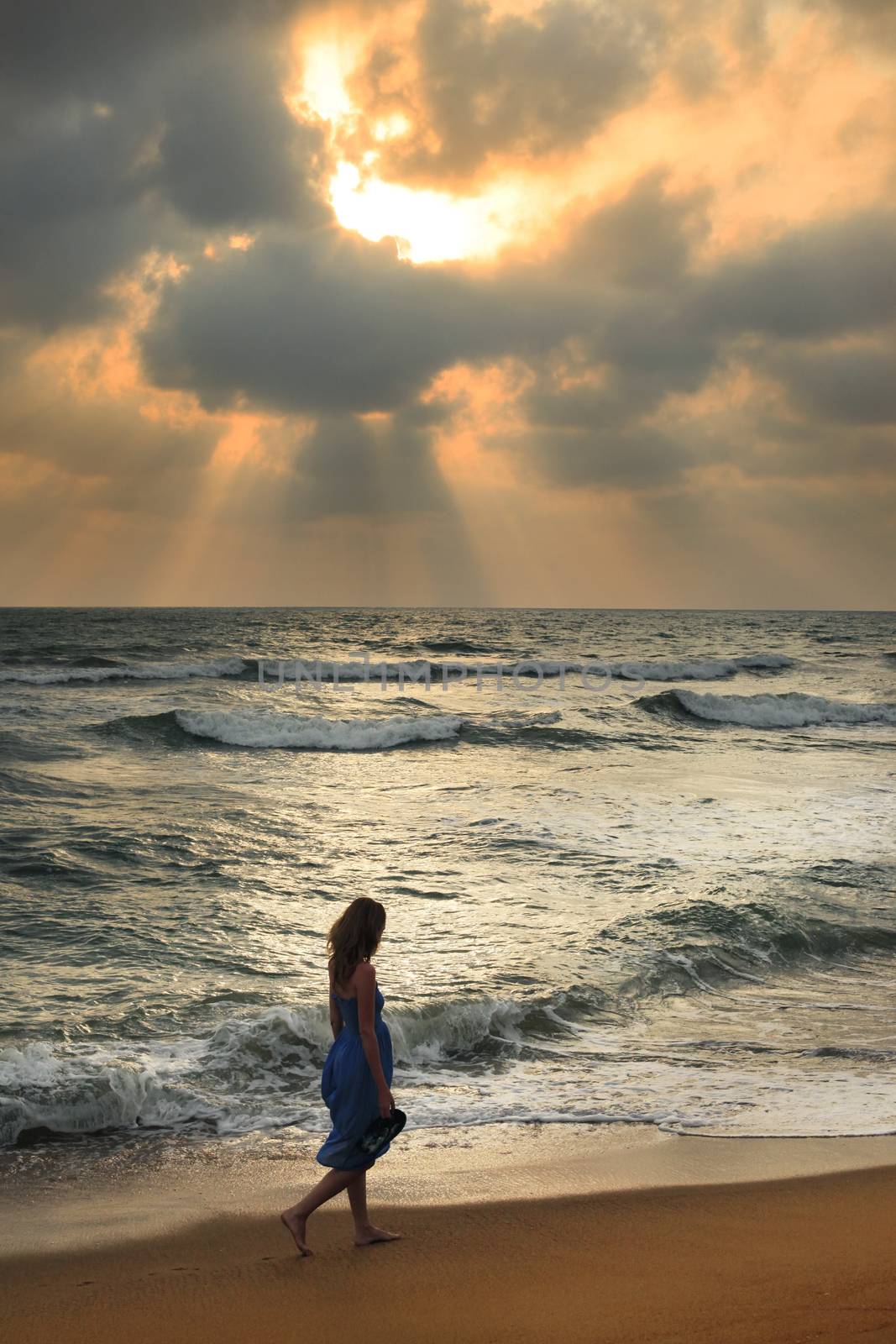 Girl on a beach on sunset by friday