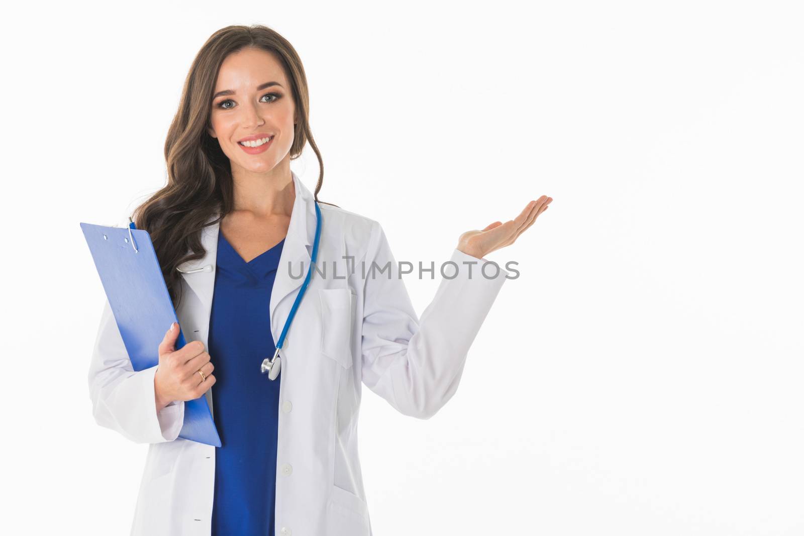 Portrait of happy smiling young female doctor showing something or blank area for text, or copyspace, isolated over white background