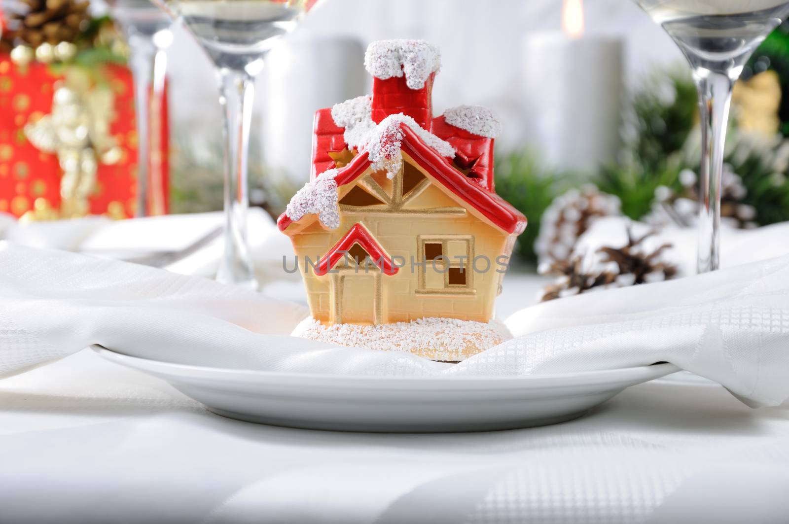 Souvenir in the form of a Christmas house on the Christmas table