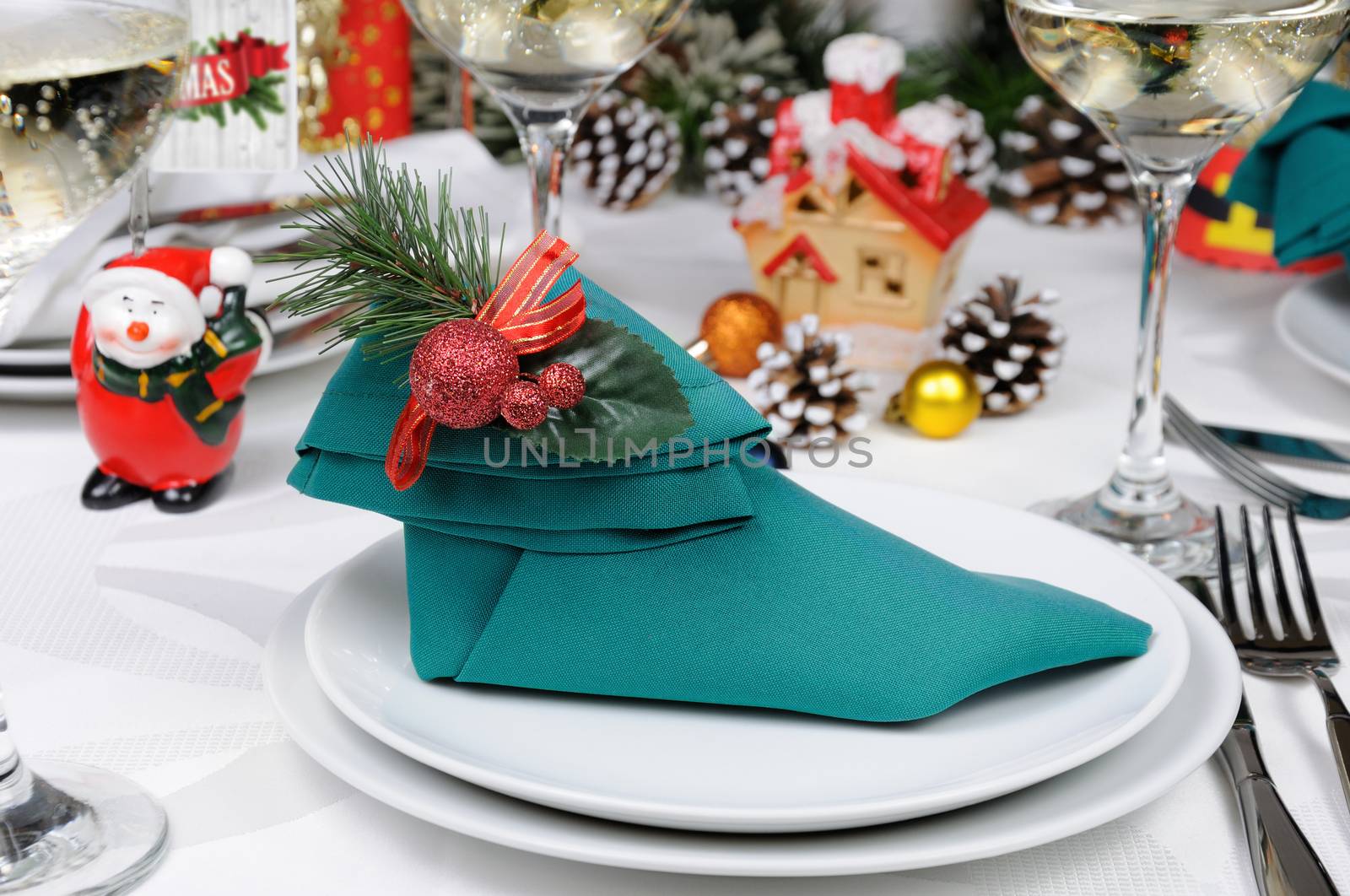 Napkin folded in the form of an Elven boot decorated on the Christmas table