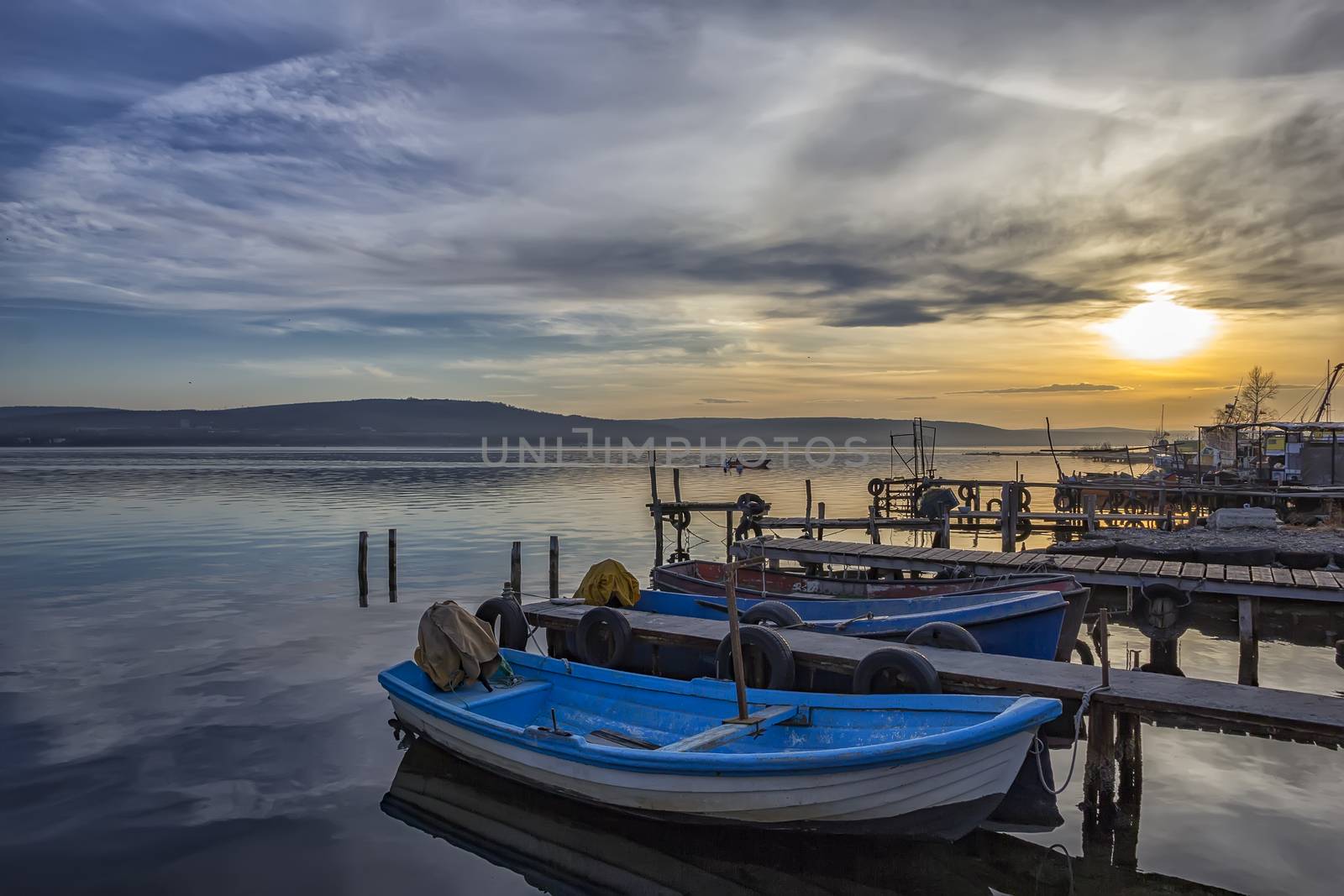 exciting sunset on harbor with boats 