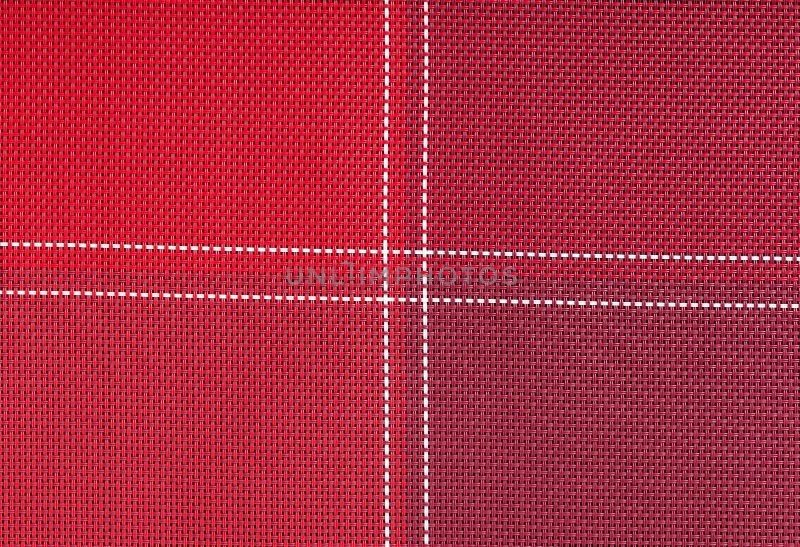 background texture of red cloth with white stitching