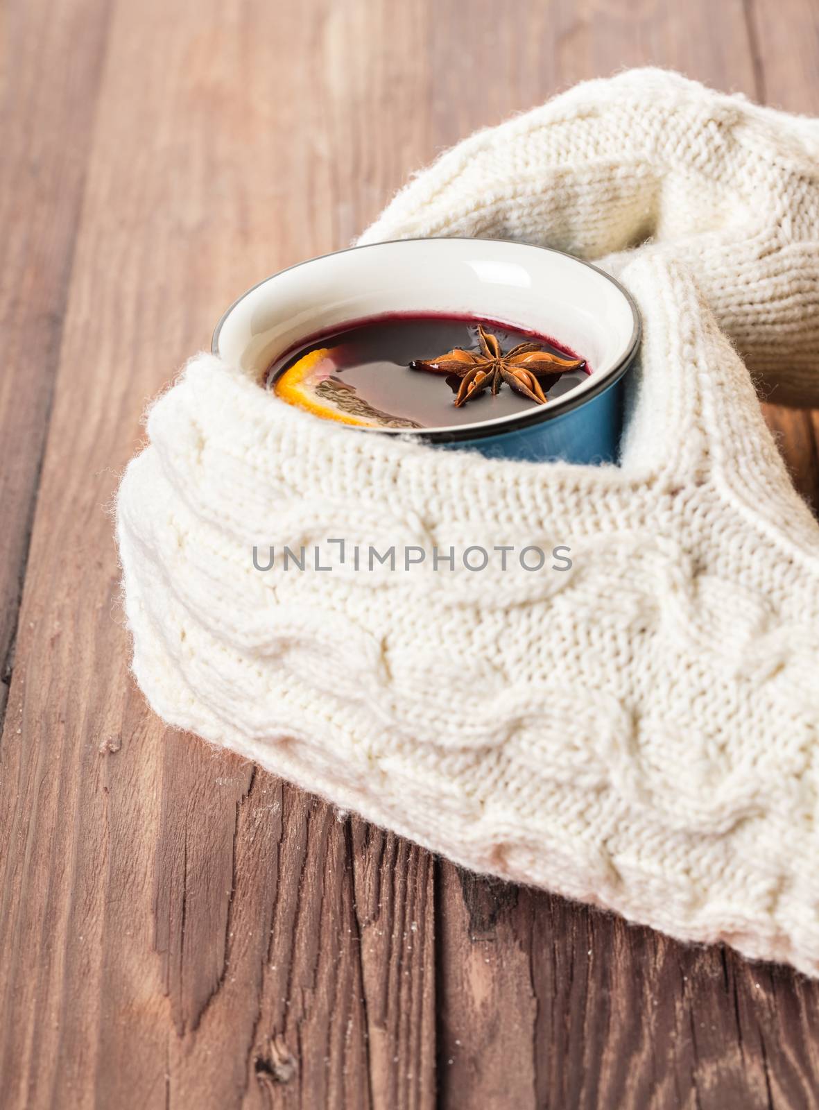 female hands in gloves holding hot mulled wine