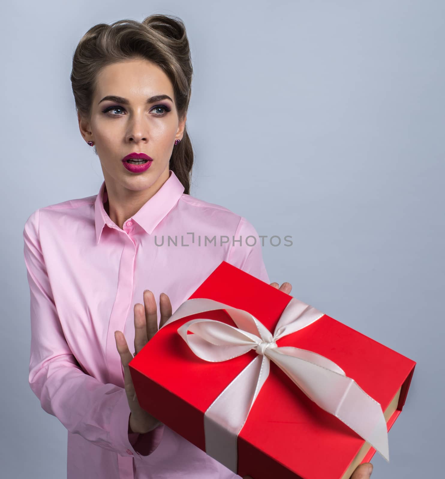 Portrait of a young woman refusing holiday gift