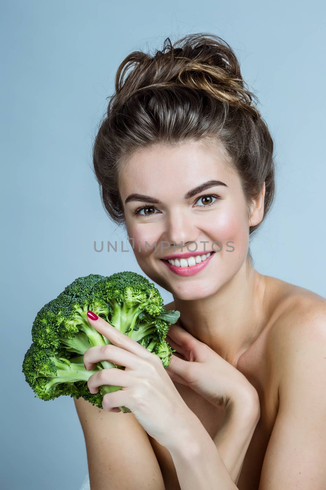 Woman holding broccoli by ALotOfPeople