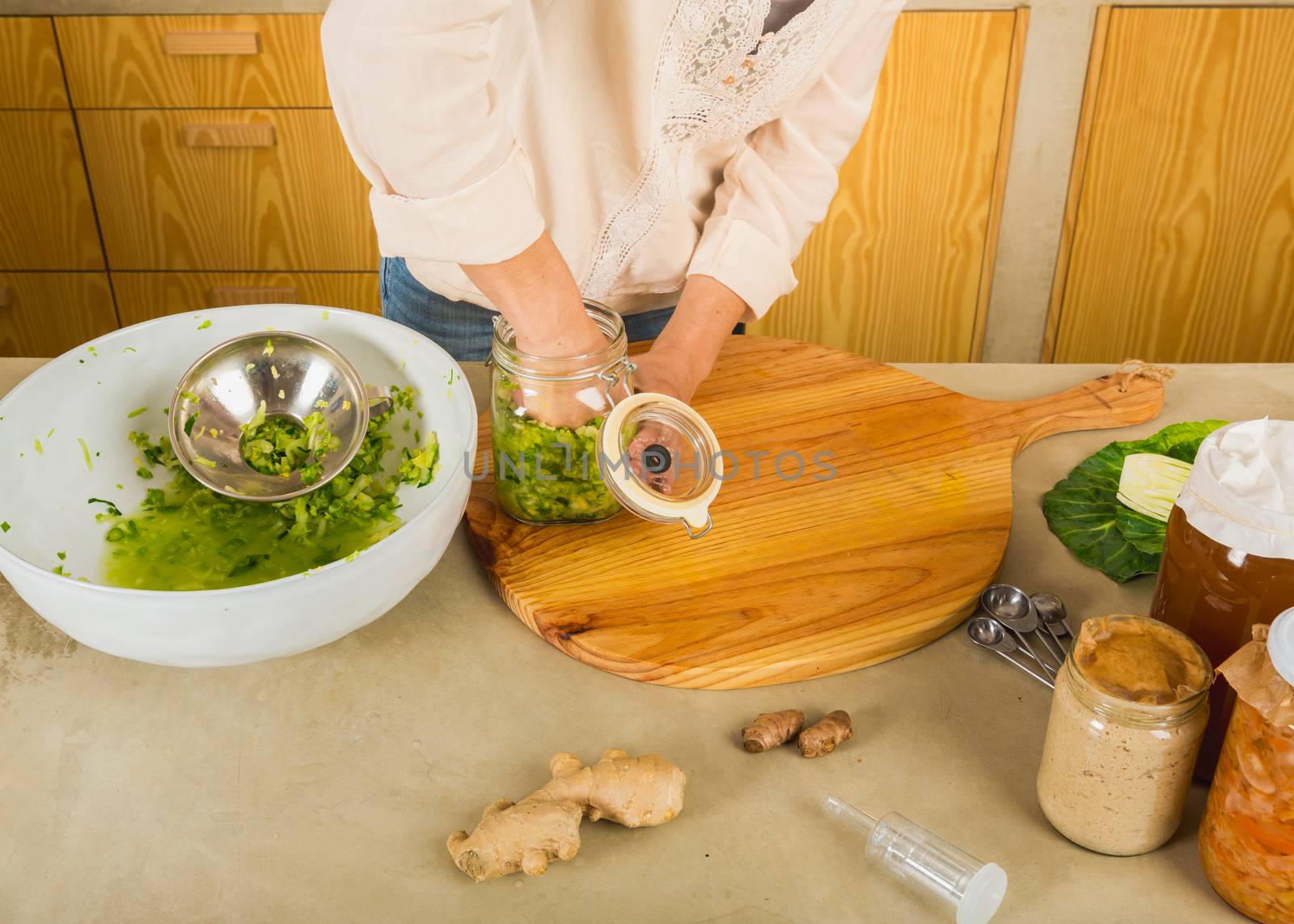 Preparing fermented preserved vegetables. Jars of cabbage kimchi and sauerkraut sour cabbage. 
