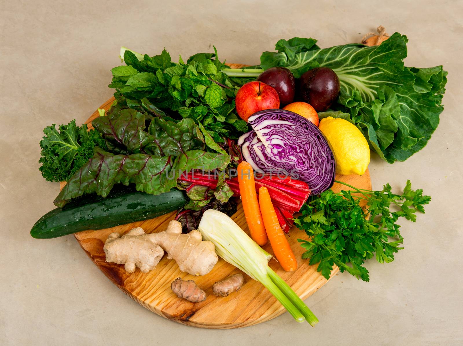 Several vegetables on top of a wooden board. Ingredients for detox diet. 