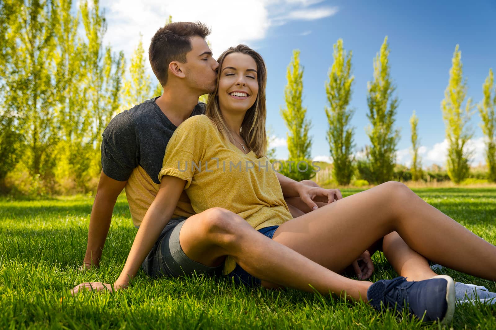 Young couple sitting on the grass and relaxing