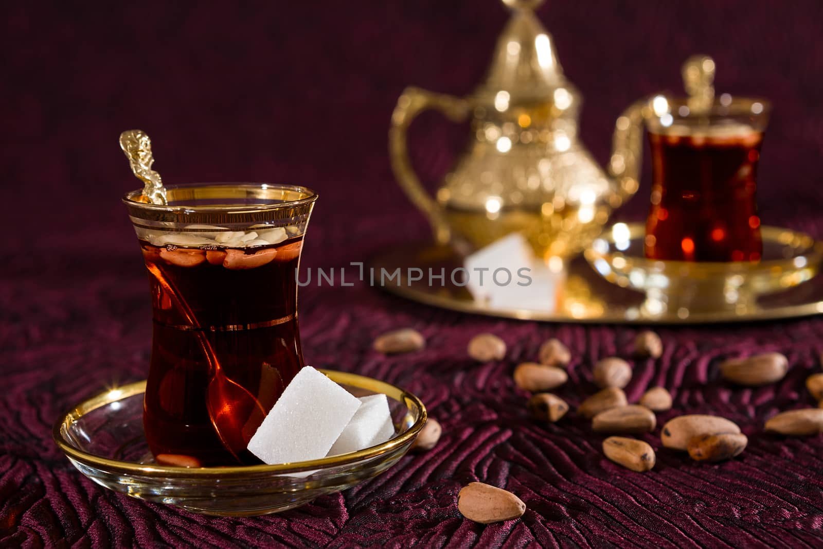 Closeup of Tunisian tea in traditional glass and pine nuts