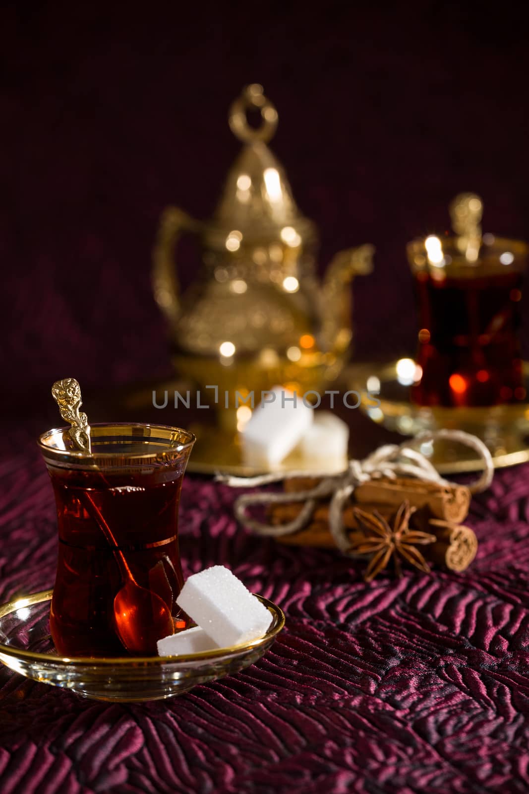 Turkish tea in traditional glass and tray on background