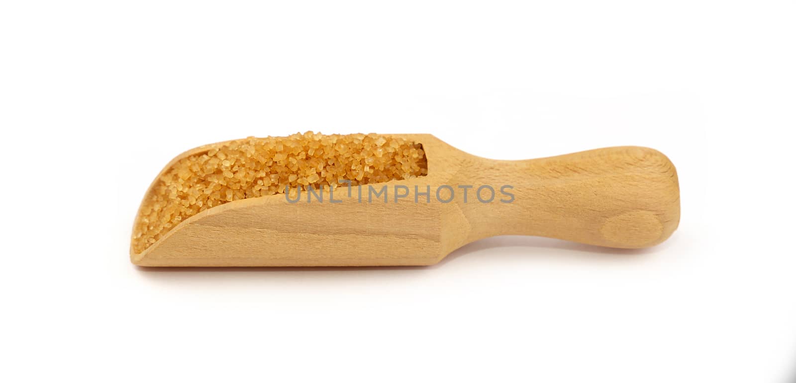 Close up one wooden scoop spoon full of raw brown cane sugar isolated on white background, low angle side view