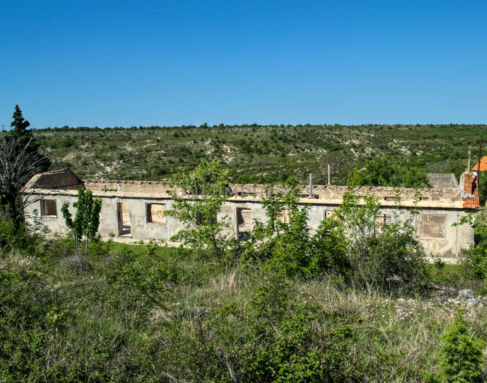 Old ruined abandoned house with only walls remaining