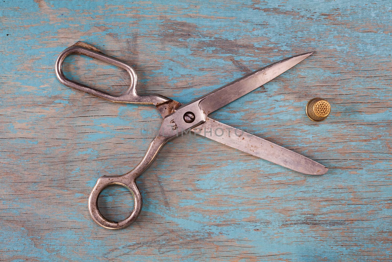 Retro sewing accessories on blue wooden background by igor_stramyk