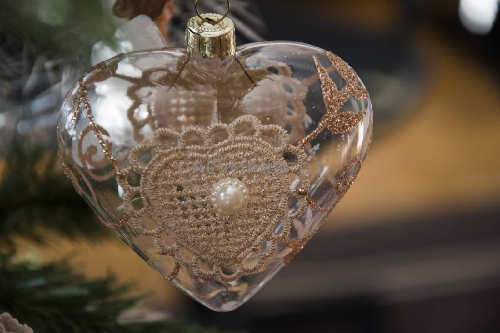 Heart ornament hanging on christmas tree. Beautiful close up holiday photo. 
