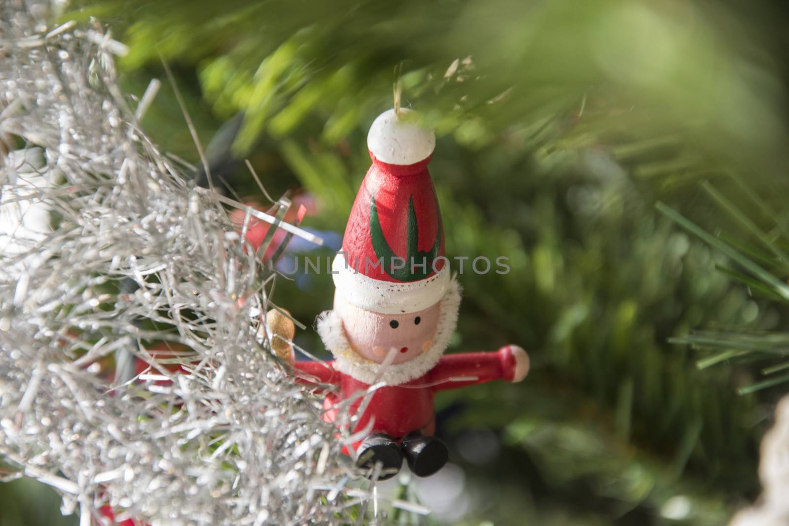 santa claus ornament hanging on christmas tree. Beautiful close up holiday photo. 
