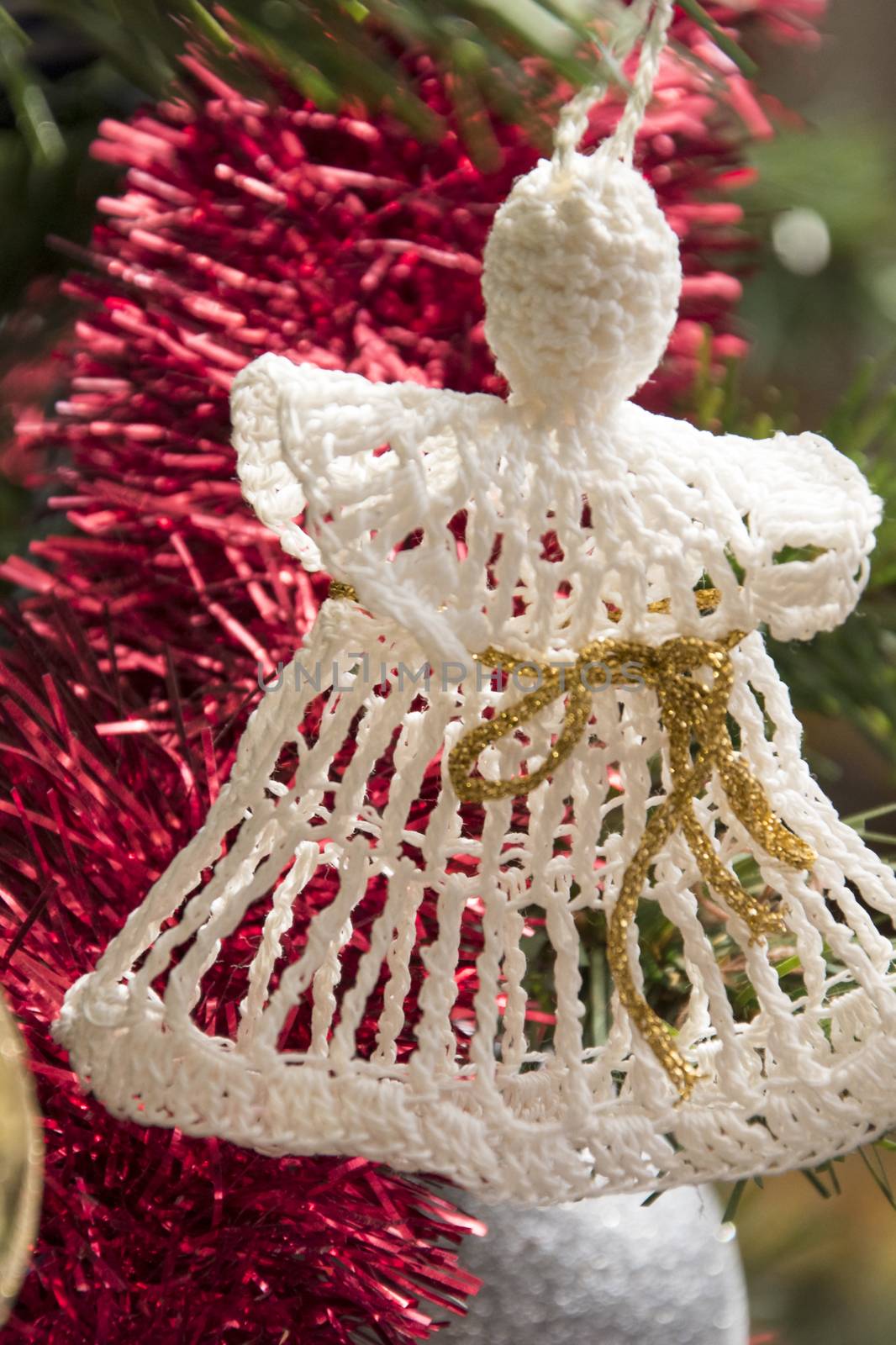  Angel ornament on christmas tree. Beautiful holiday photo. 
