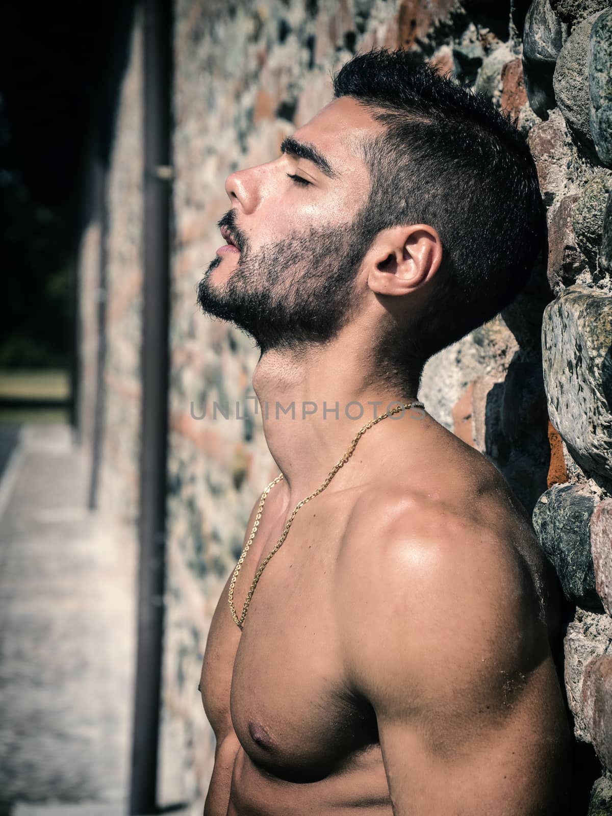 Shirtless young man outdoor against brick wall by artofphoto