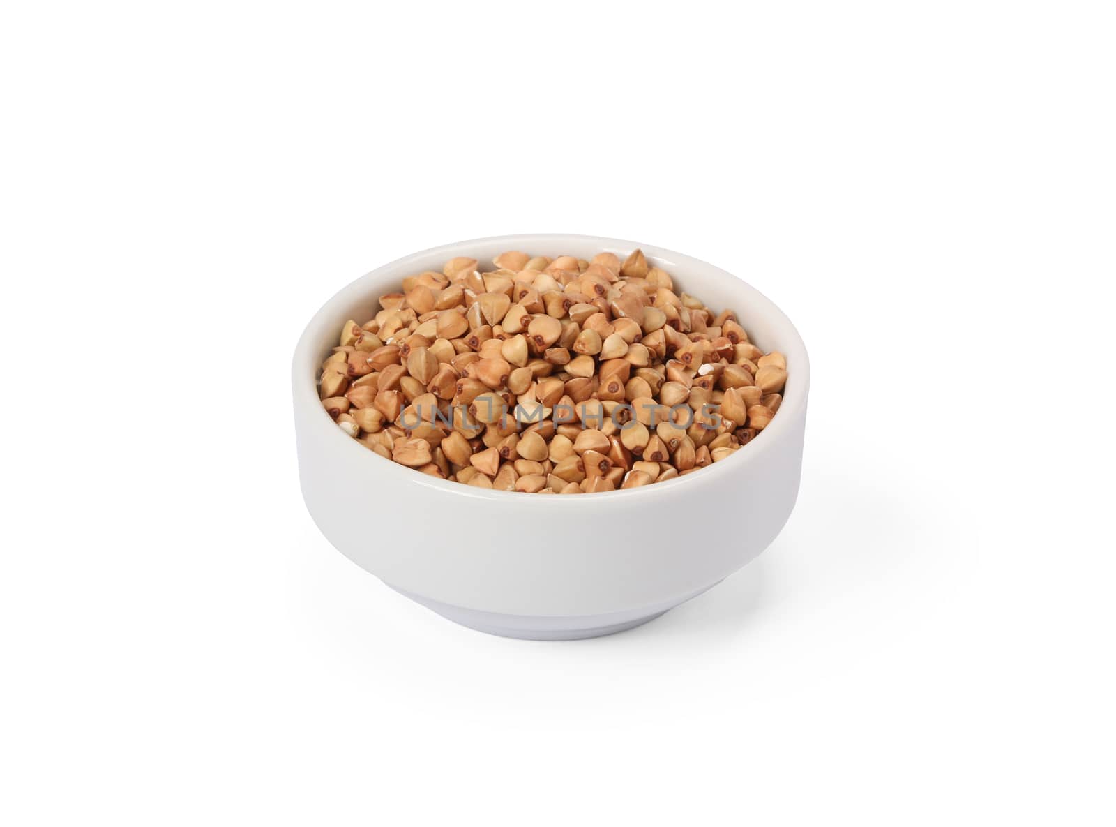 Buckwheat groats in whitebowl isolated on white background.