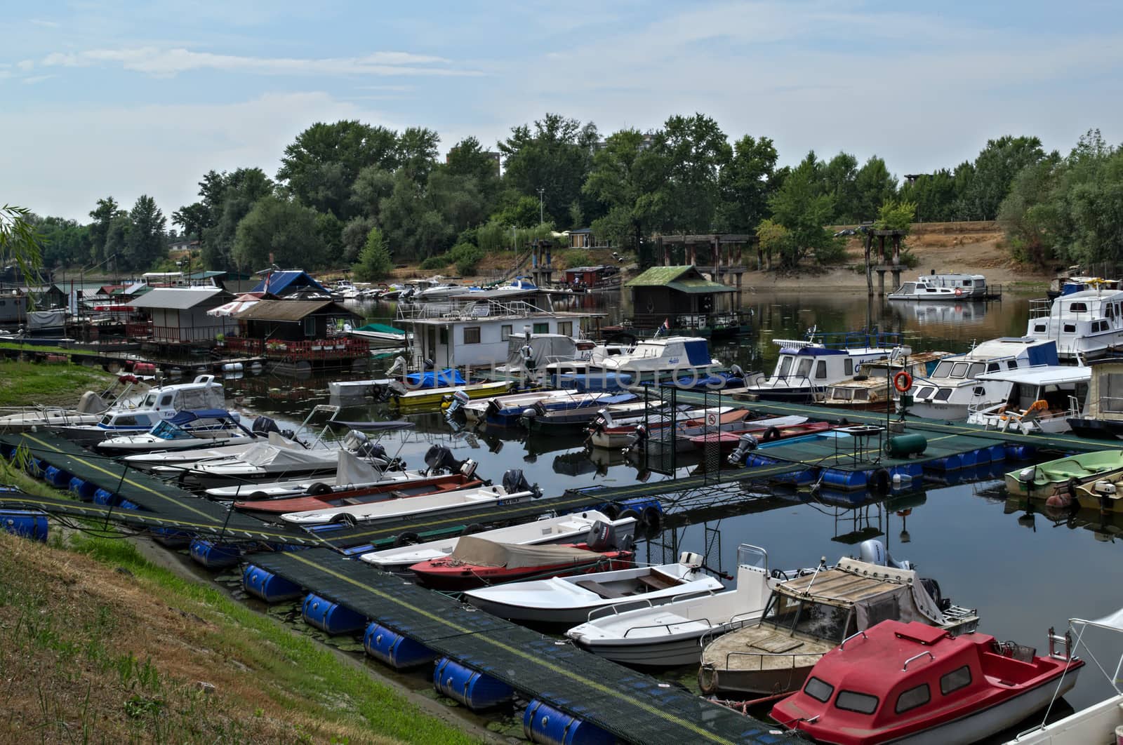 Boats and rafts sitting at Danube river dockside harbor