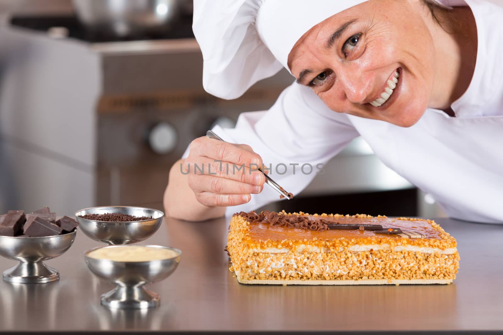 Pastry chef decorating cake yolk and cream
