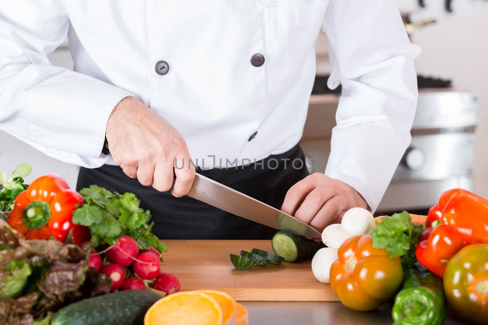 Chef cutting fresh and delicious vegetables for cooking