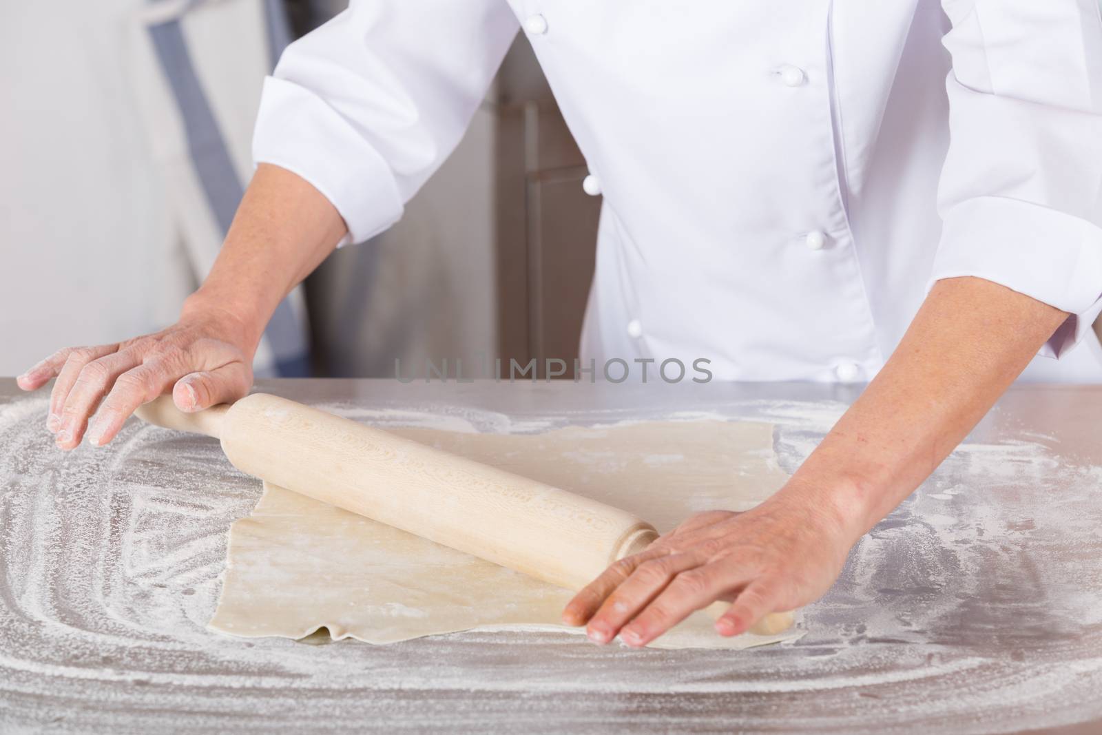 Pastry kneading a dough of a cake