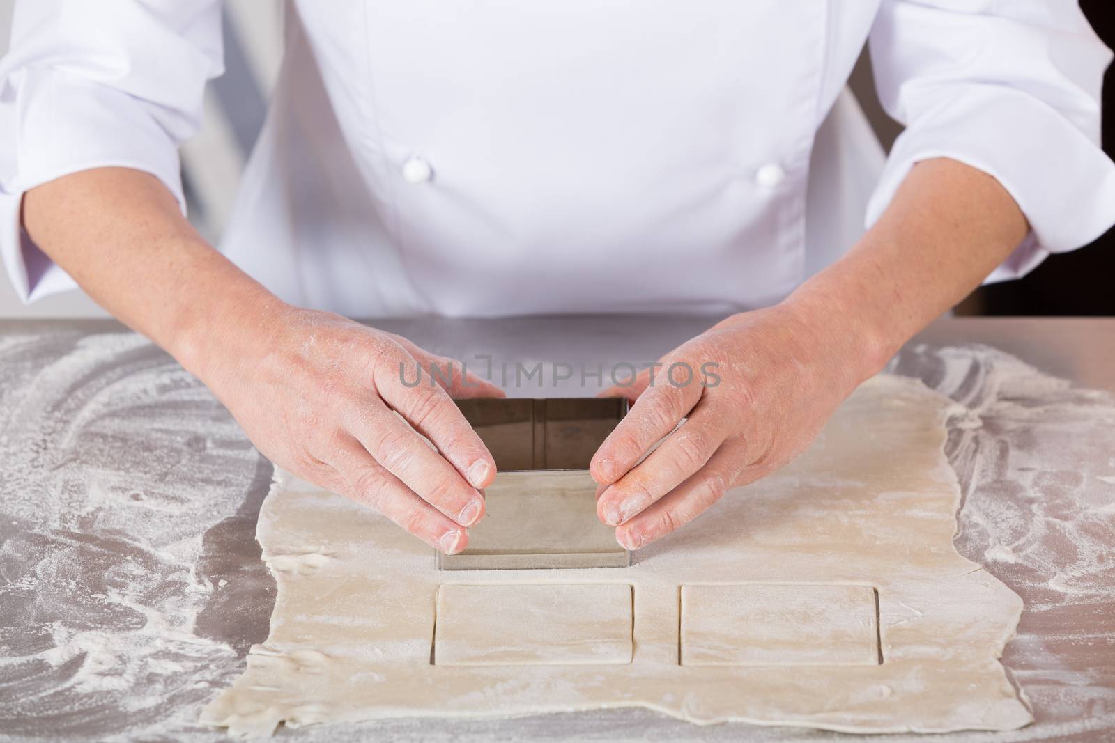 Pastry kneading a dough of a cake
