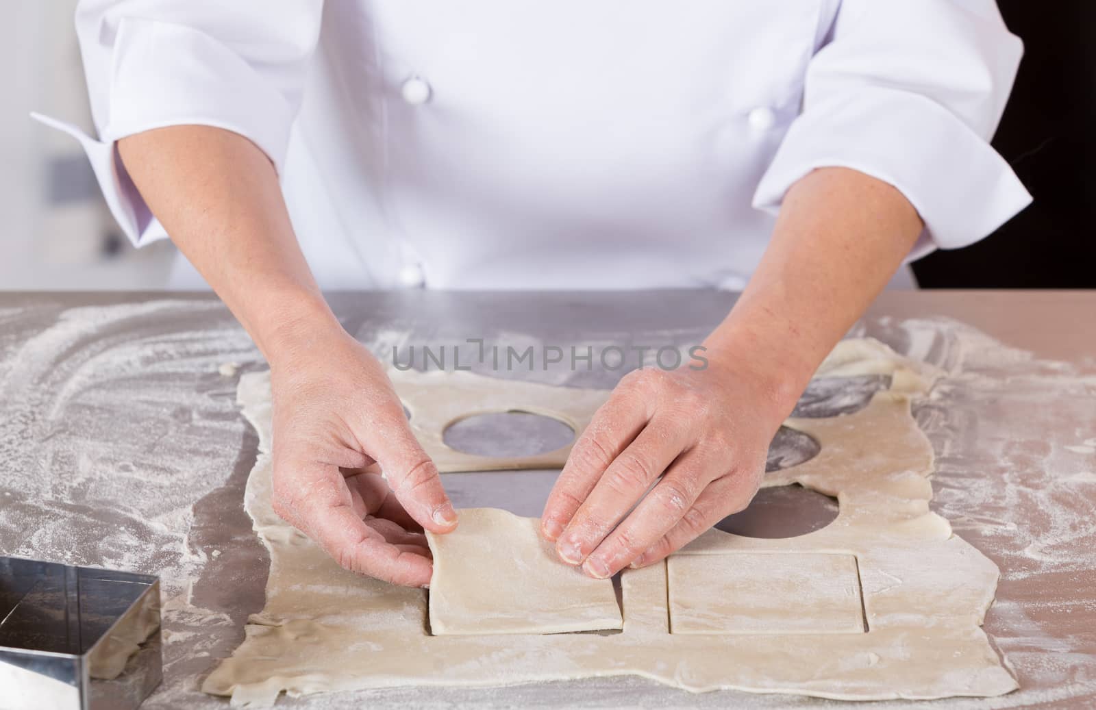 Pastry kneading a dough of a cake