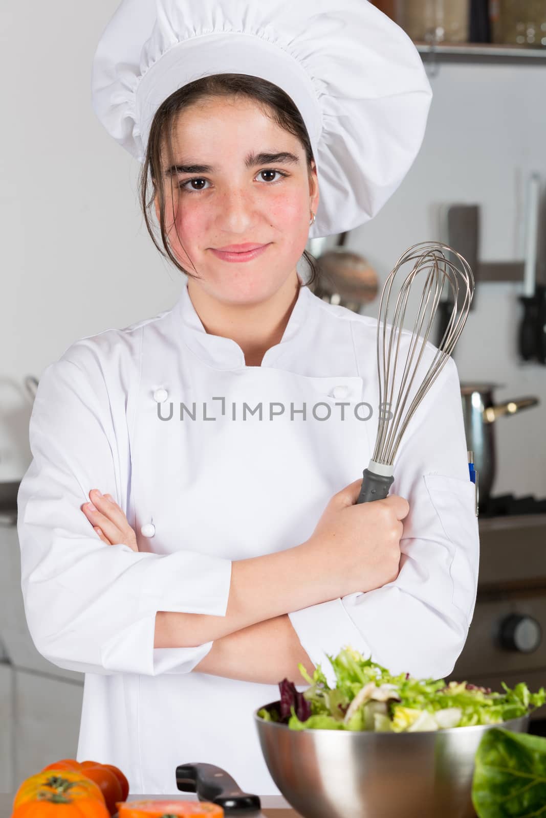 Teen girl in the kitchen preparing a salad