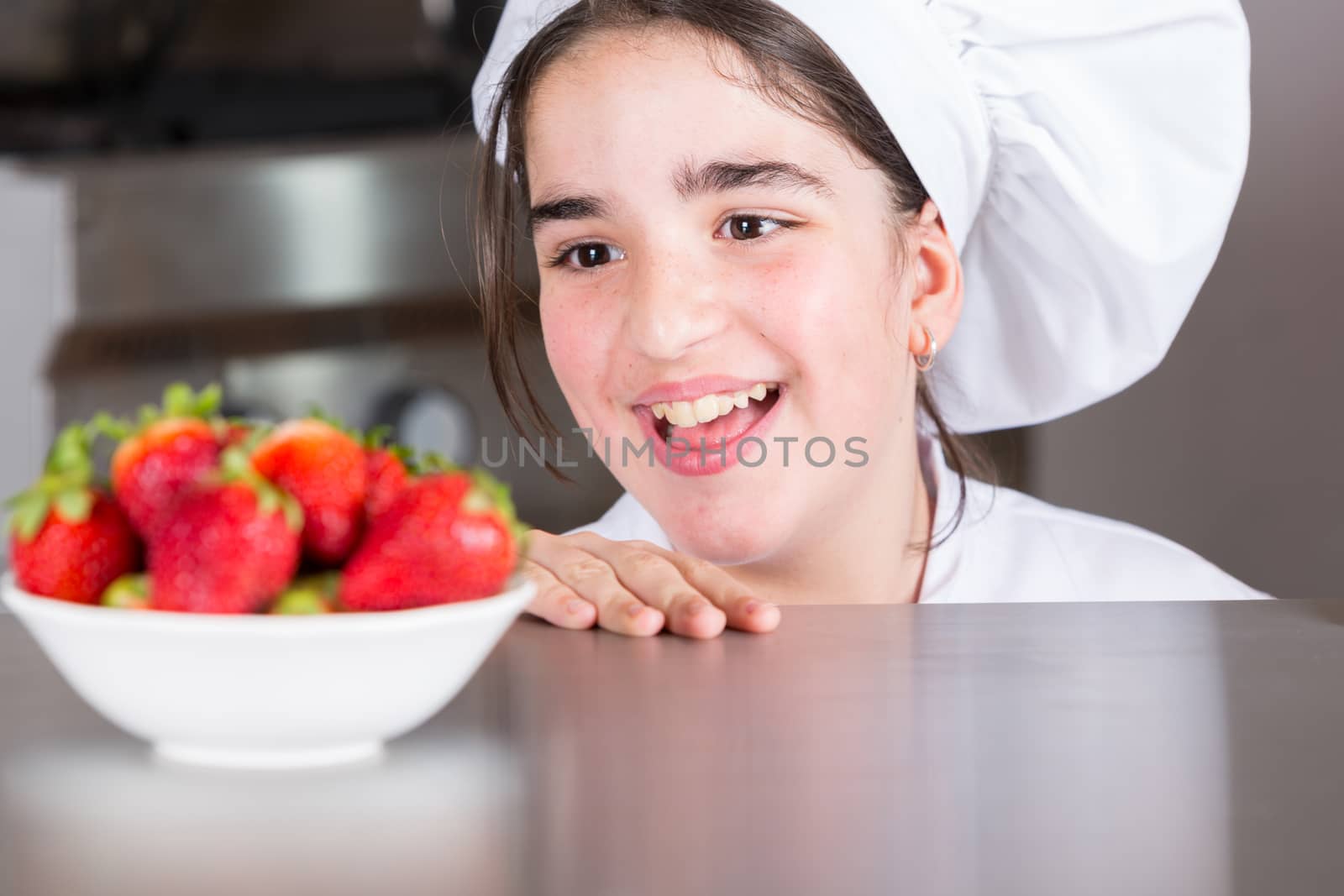 Teenage girls looking delicious fresh strawberries