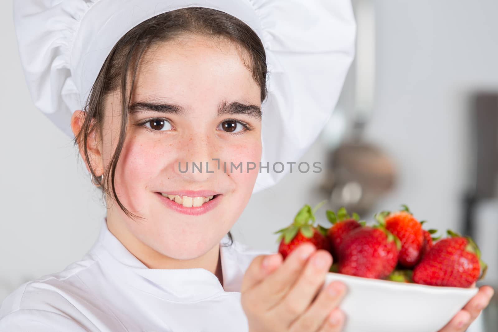 Teenage girls looking delicious fresh strawberries