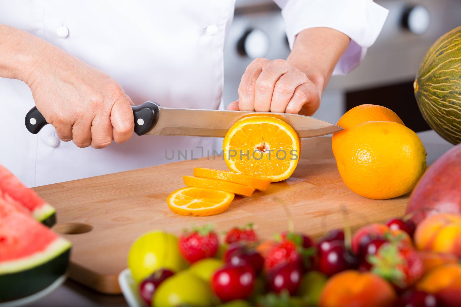 Chef preparing a delicious salad of mixed fruits