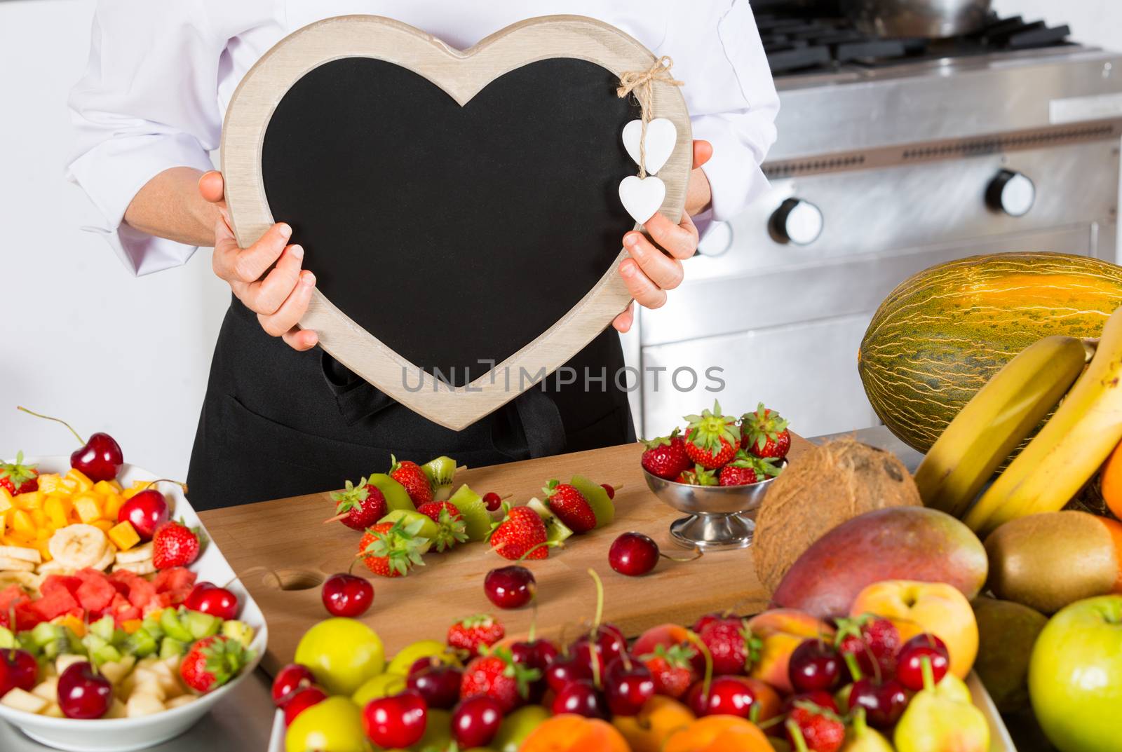 Chef with a blackboard in the form of heart