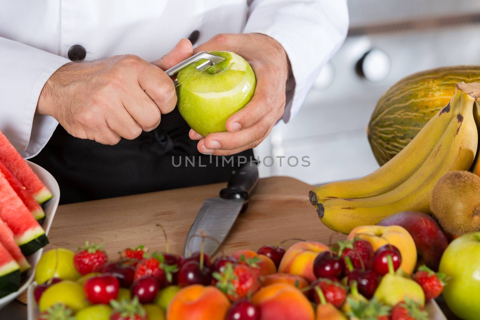 Chef cutting a sour apple green