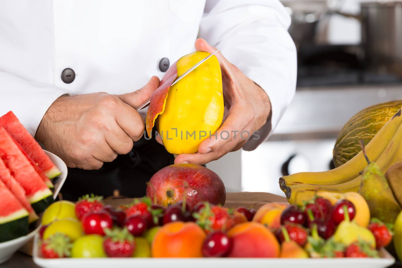 Chef cutting a delicious ripe mango