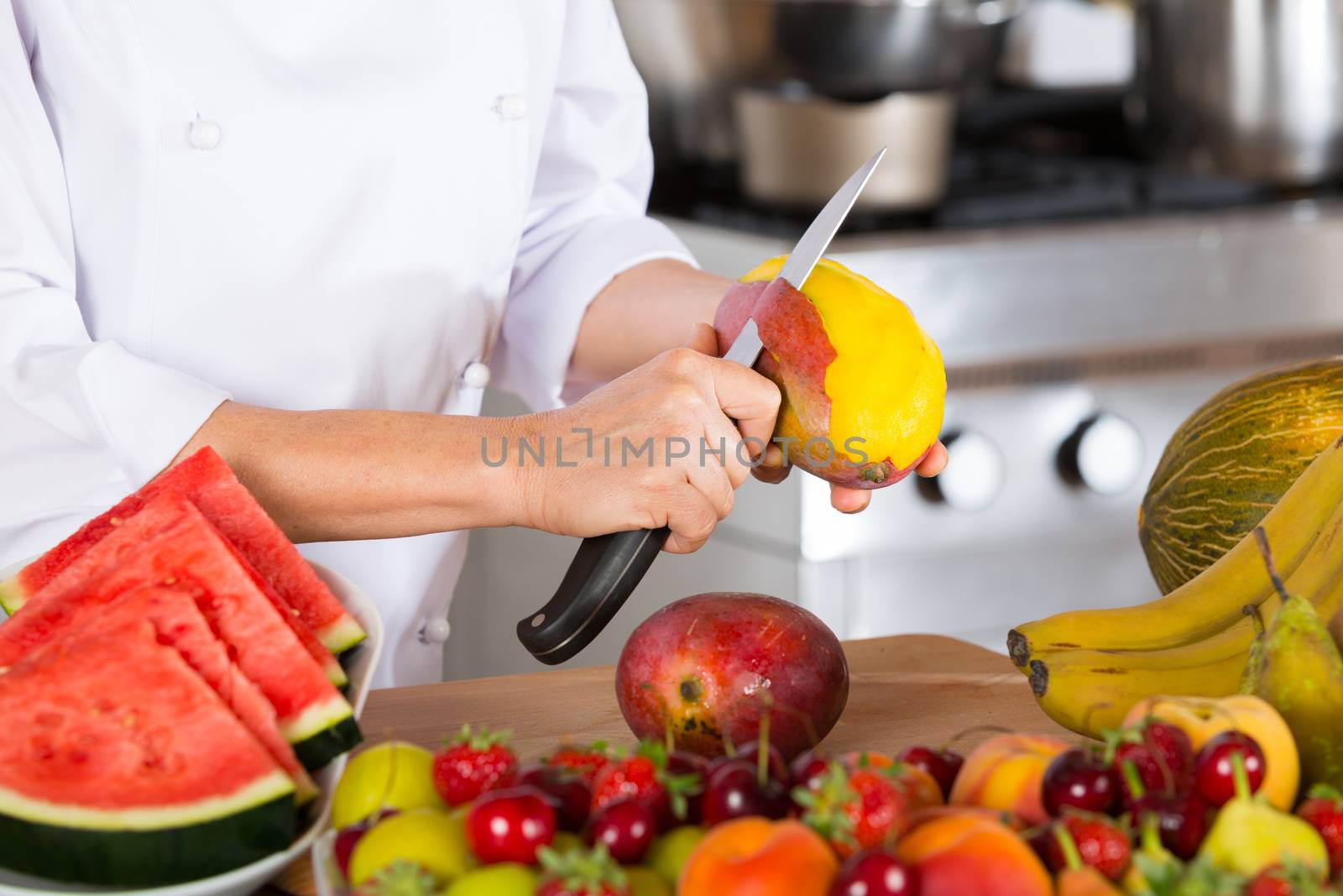 Chef cutting a delicious ripe mango