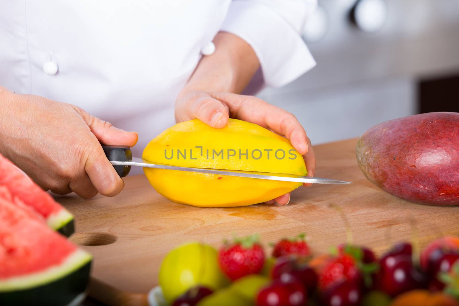 Chef cutting a delicious ripe mango