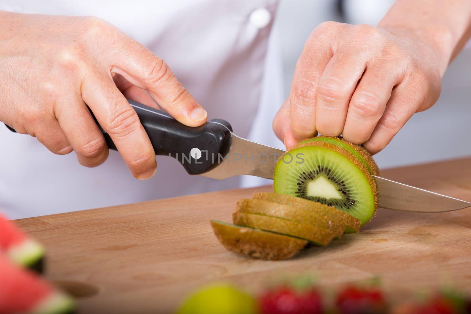 Chef cutting a delicious kiwi acid